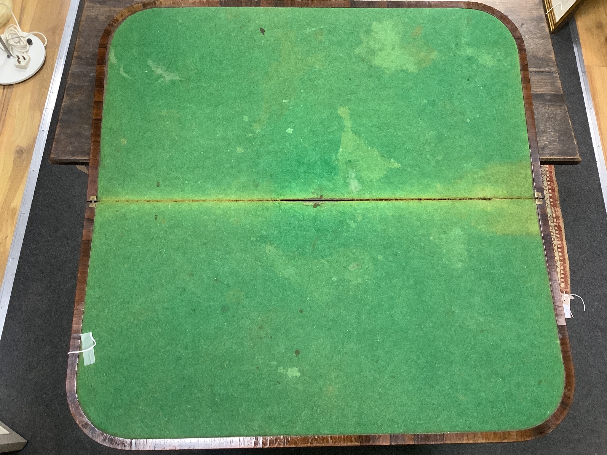 A Regency amboyna banded rosewood D shape folding card table, width 92cm, depth 46cm, height 72cm
